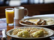 Eggs Benedict with hashbrowns and French toast  with two eggs and sausage at Old Town Burger &amp; Breakfast in Battle Ground.