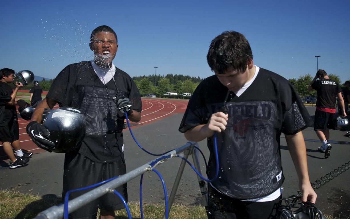 Union's Marcus Boyd takes a water break during the first day of high school football practice.