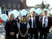 Camas: Pacific Crest Academy third graders Avery Deringer, left, Bella Groff, David Marshall and Christopher Spencer were among the students who tied their prayer intentions onto a giant Rosary made of balloons on Oct.