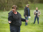 Columbian reporter Sue Vorenberg practices her moves as a slow &quot;Romero zombie&quot; during her day as an extra in director Nick Hagen's new zombie Web series &quot;Zombie Ridge.&quot; Hagen, center, and Sunshine, an actress from his &quot;The Haunting of Sunshine Girl&quot; YouTube series, right, discuss details in the background.