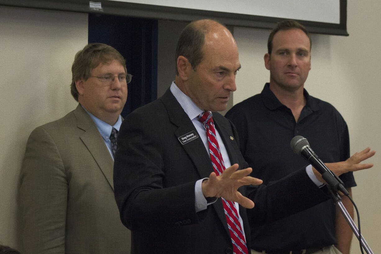 Clark County Auditor Greg Kimsey, center, is accompanied by Assessor Peter Van Nortwick and Commissioner Steve Stuart on Wednesday to discuss the county charter process at a lunch event.