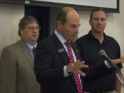 Clark County Auditor Greg Kimsey, center, is accompanied by Assessor Peter Van Nortwick and Commissioner Steve Stuart on Wednesday to discuss the county charter process at a lunch event.