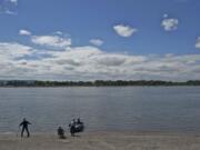 Sand Tampers Club members, from left, Guy Miller, 54, of Felida, Art McGrew, 73, of Vancouver, and Wally Schriener, 76, of Battle Ground, fish the Tena Bar on The Columbia River on Friday.