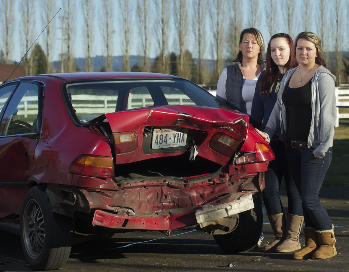 Karen Munger, left, is searching for clues about a hit-and-run driver who crashed into a 1995 Honda Civic driven by her daughter, LaKell Munger, right, 16, injuring her passenger, Ruchelle Shamp, 17, center.