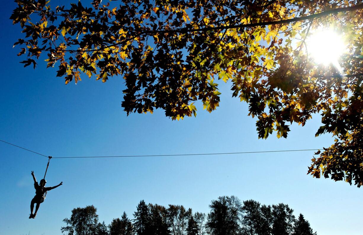 La Center High School junior Carly Goglin, 16, completes an obstacle course in the trees on Friday October 18, 2013.