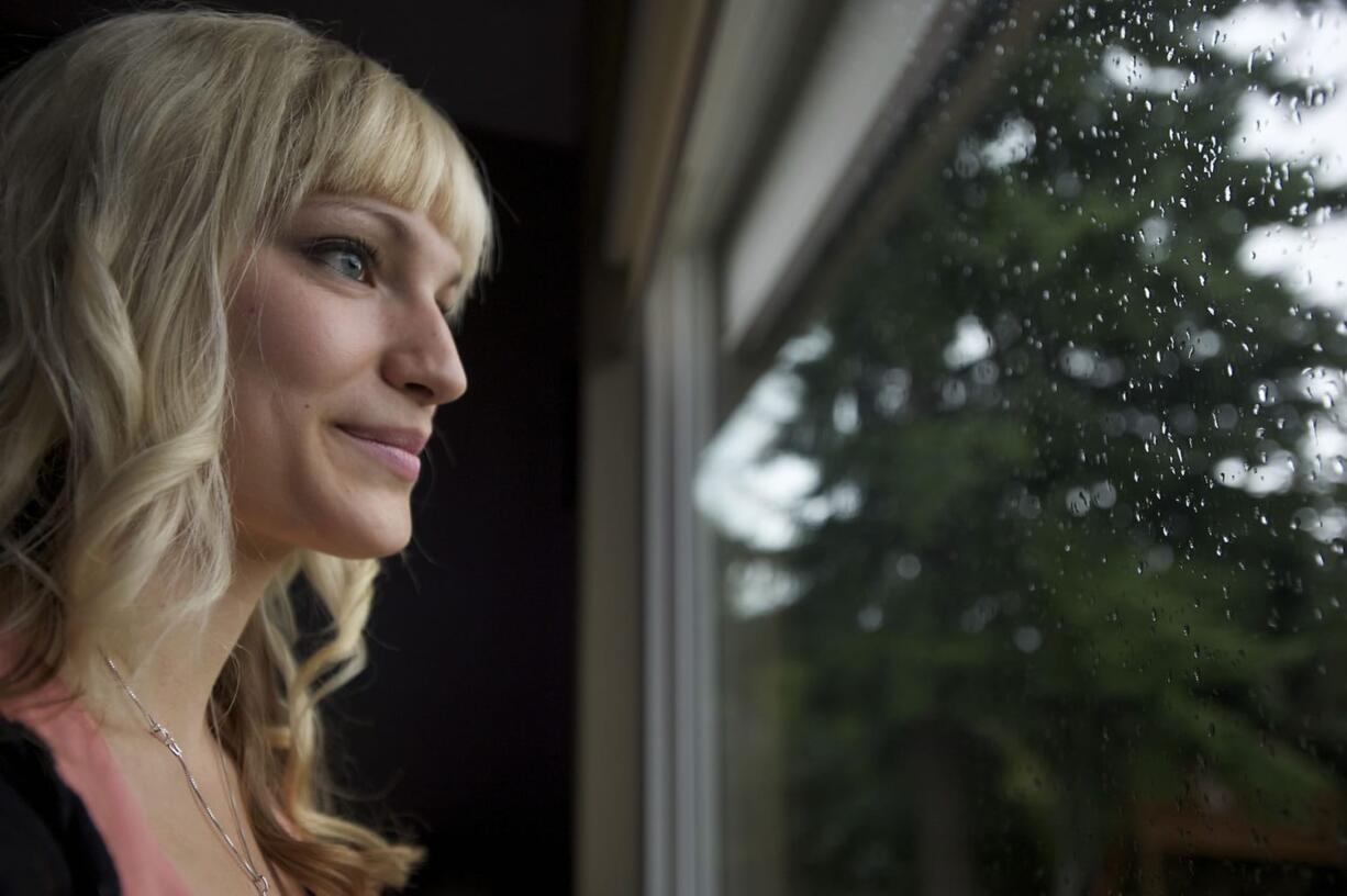 Cancer survivor Jesie Jobson, 28, looks out the window at her Vancouver home Sept. 5. Jobson, who had had three breast tumors removed years earlier, was diagnosed with breast cancer in March.