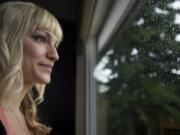 Cancer survivor Jesie Jobson, 28, looks out the window at her Vancouver home Sept. 5. Jobson, who had had three breast tumors removed years earlier, was diagnosed with breast cancer in March.