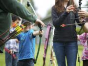 Tyler Miles, 5, of Vancouver shoots an arrow at the 2012 National Get Outdoors Day event at the Fort Vancouver National Site.