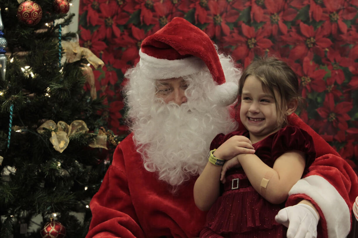 Chloe Amash, 6, visits with Santa at the Vancouver Autism Moms Support Group&#039;s second annual Sensory Santa event for special-needs children and their families on Saturday. Chloe has autism spectrum disorder, so having a quieter, more softly lit place to meet Santa was ideal for her.