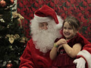 Chloe Amash, 6, visits with Santa at the Vancouver Autism Moms Support Group&#039;s second annual Sensory Santa event for special-needs children and their families on Saturday. Chloe has autism spectrum disorder, so having a quieter, more softly lit place to meet Santa was ideal for her.