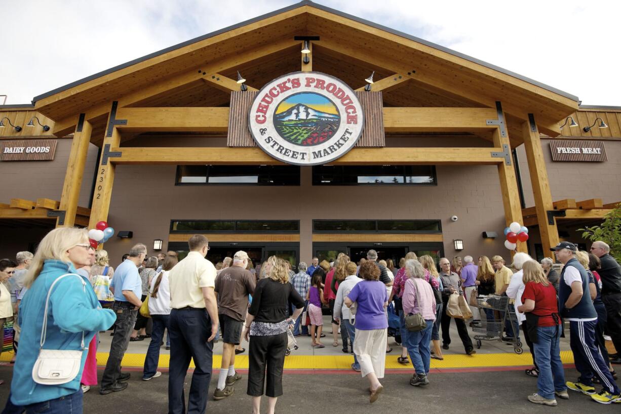 Customers enter Chuck's Produce &amp; Street Market after a ribbon cutting ceremony this morning celebrating its new Salmon Creek store.