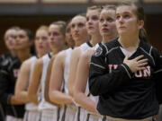 Kendra Preuninger, foreground, stands with her teammates before the start of a game Tuesday.