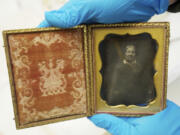 Meagan Huff, museum technician at Fort Vancouver National Historic Site, shows a daguerreotype that is the only known image of Marguerite McLoughlin.