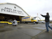 Joshua Staley, right, an A&amp;P technician and event staff supervisor, helps direct Tom Sturdy, also an event staff supervisor, as he moves a 1941 U.S.