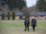 Adam Kravitz, left, founder of Outsiders Inn, strolls with Bill Ritchie of the Clark County Commission on Aging on Dec. 3 outside Safe Harbor Church of the Nazarene in Vancouver, where the Council for the Homeless had planned to build a village of 40 tiny houses for the homeless. Wednesday, the church backed out of the project, and organizers are looking for a new site.