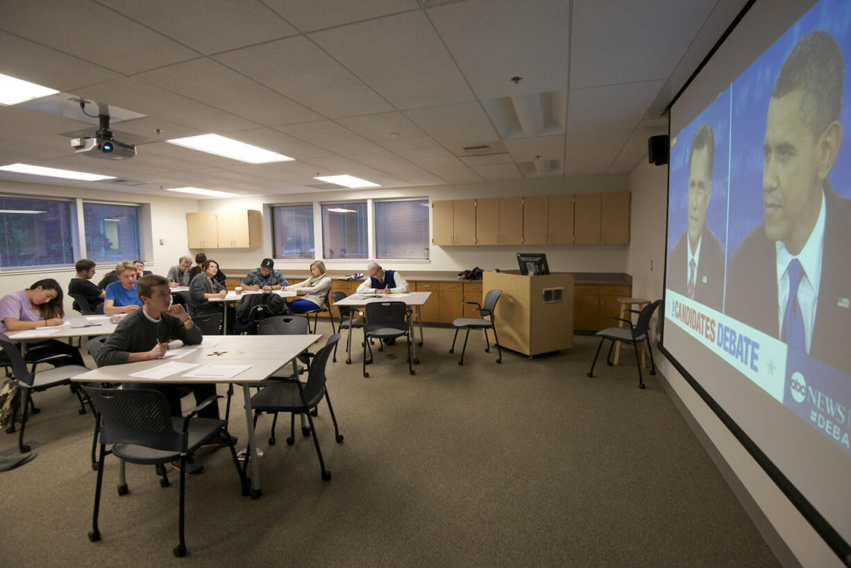 Students with the Clark College debate team listen and take notes during the third presidential debate Monday.