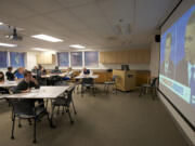 Students with the Clark College debate team listen and take notes during the third presidential debate Monday.