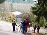 Mattie Roscoe and her grandchildren are pictured in the Roscoe family calendar as they take an early morning walk to pick apples near their home in Hockinson.