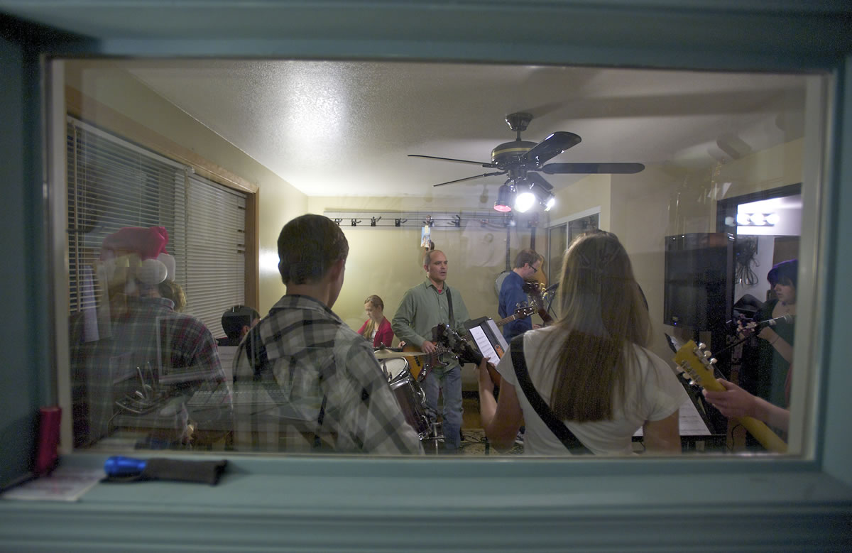 As students crowd around inside the &quot;jamming room,&quot; Rob Melton, owner and primary teacher of the Opus School of Music, plays bass and leads his students in a rehearsal. The students are preparing for the second annual Autumnal Concert on Dec.