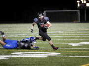 Running Back Nate Beasley gets past a tackle during Saturday night's game against Federal Way in the Class 4A state quarterfinals.