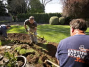 Earthworks Excavating Services employees, from left, Nathan Eterno, Jeff Eterno and Andrew Aasen, dig a power trench.