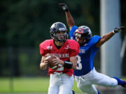 John Payne, a graduate of Camas, closes in on quarterback Tyler Bergeron of Battle Ground during the Freedom Bowl Classic.