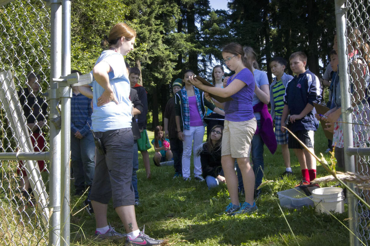 Zoey Mikalatos, center, reports on plant varieties around Gaiser Pond.