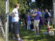 Zoey Mikalatos, center, reports on plant varieties around Gaiser Pond.