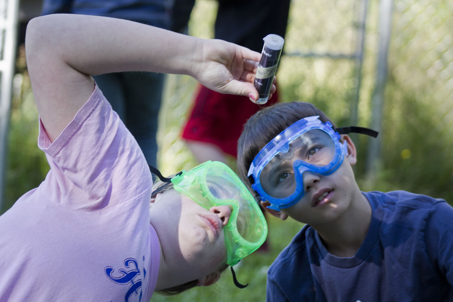 Sixth-grade earth science students Molly Hongel, right, and Austin Chou check the phosphate levels in Gaiser Pond.