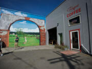 Chris and Christy Green of Vancouver walk out of Torque Coffee on Sunday. The shop was robbed at gunpoint as an employee was opening for the day.