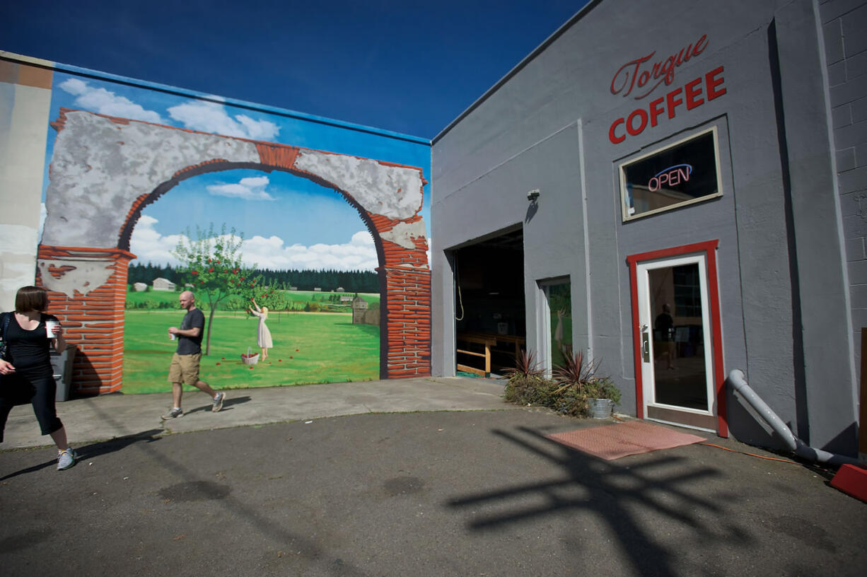 Chris and Christy Green of Vancouver walk out of Torque Coffee on Sunday. The shop was robbed at gunpoint as an employee was opening for the day.