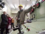 BPA electrical engineer Jeff Hildreth, center, leads a tour on Jan.