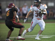 Battle Ground's Kevin Haynes tries to get past Prairie's Jacob Austin during the first half at District Stadium on Friday.