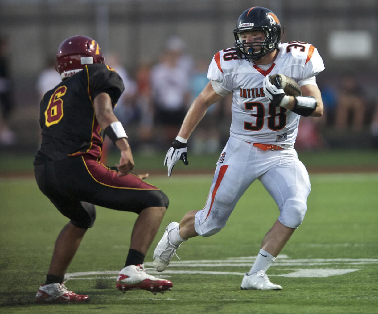 Battle Ground's Kevin Haynes tries to get past Prairie's Jacob Austin during the first half of Friday's game at District Stadium in Battle Ground.