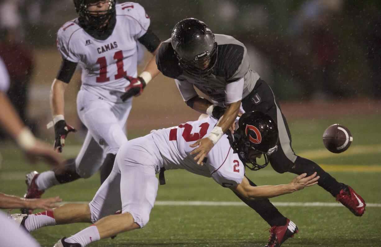 Camas' Zach Eagle (2) knocks the ball from Union's Treve Ensley and recovers the fumble for the Papermakers on Friday at McKenzie Stadium.