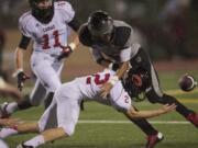 Camas' Zach Eagle (2) knocks the ball from Union's Treve Ensley and recovers the fumble for the Papermakers on Friday at McKenzie Stadium.