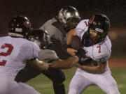 Camas' Nate Beasley, #7,  carries the ball against Union at McKenzie Stadium, Friday.