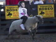 Andrea Oehler rides during the Mutton Bustin' portion of the Vancouver Rodeo on July 3 at the Clark County Saddle Club.