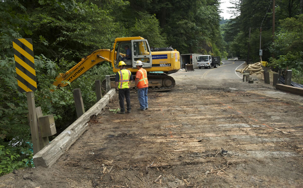 Construction crews prepare for the removal of the Cougar Creek Bridge along Washougal River Road on Thursday.