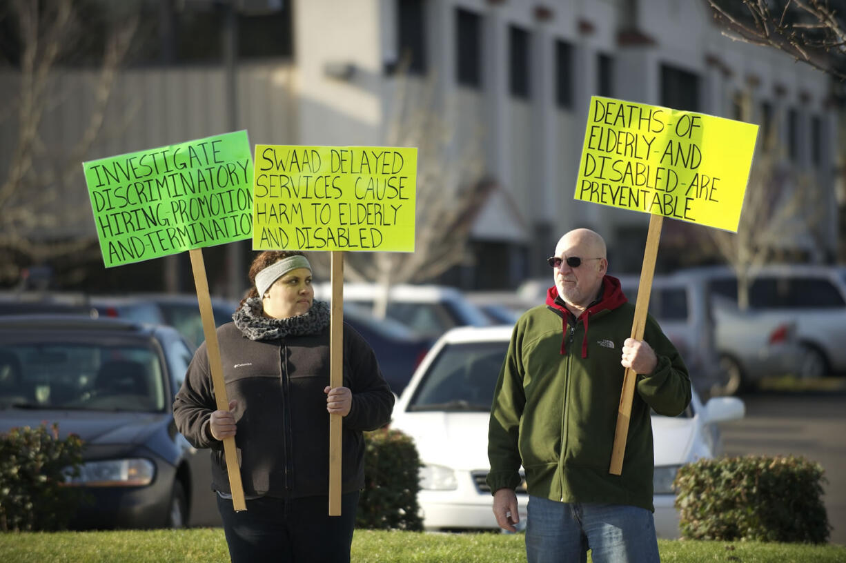 On Jan. 17, former and present case managers for the Southwest Washington Agency on Aging and Disabilities, including Skyler Dorsey-Schlenker, left, and David Benedicktus, picketed outside the agency office in Hazel Dell.