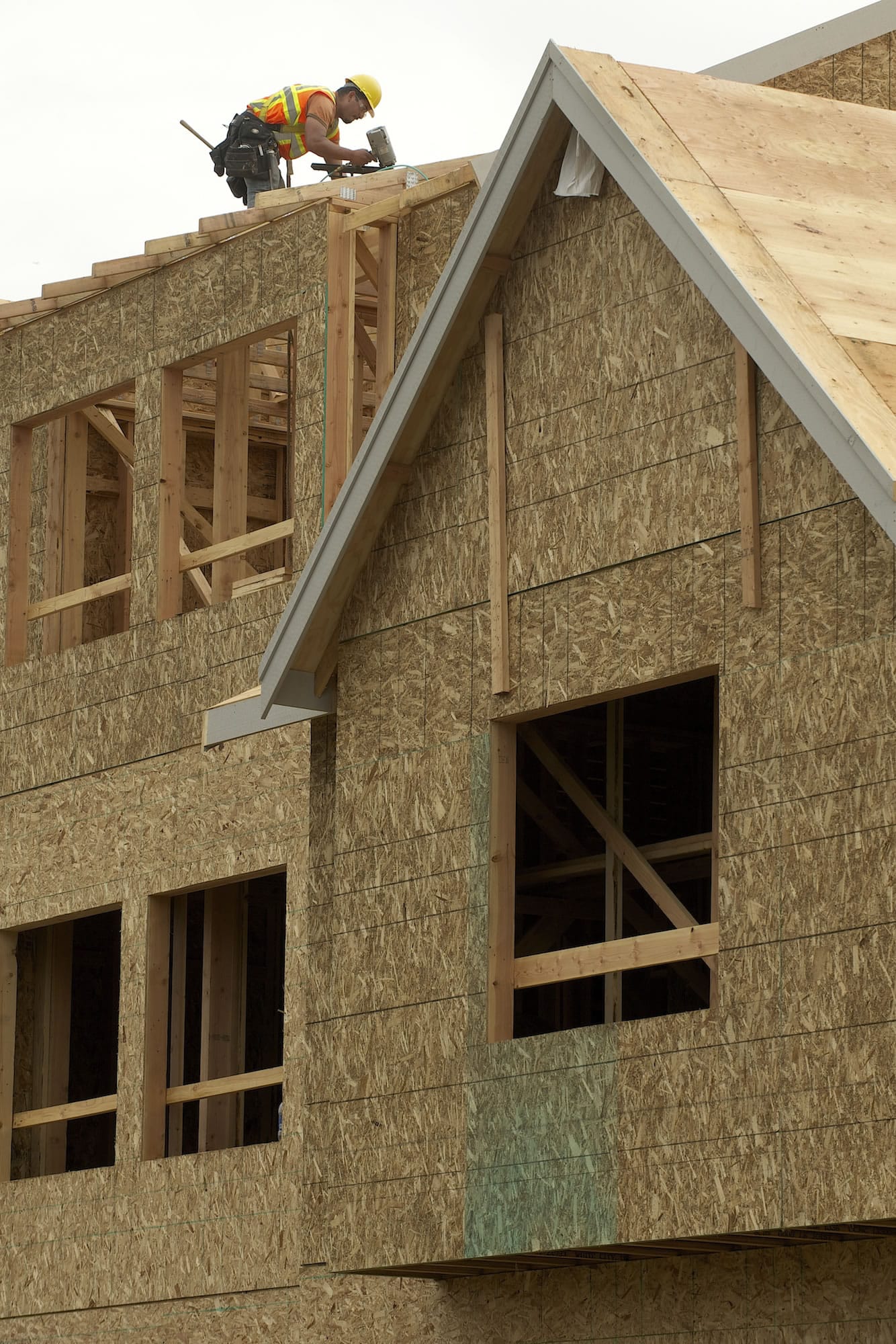 A Presto Homes worker builds a roof Tuesday at the Timbers at Towne Center in Hazel Dell.