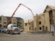 A Presto Homes worker builds a roof Tuesday at the Timbers at Towne Center in Hazel Dell.