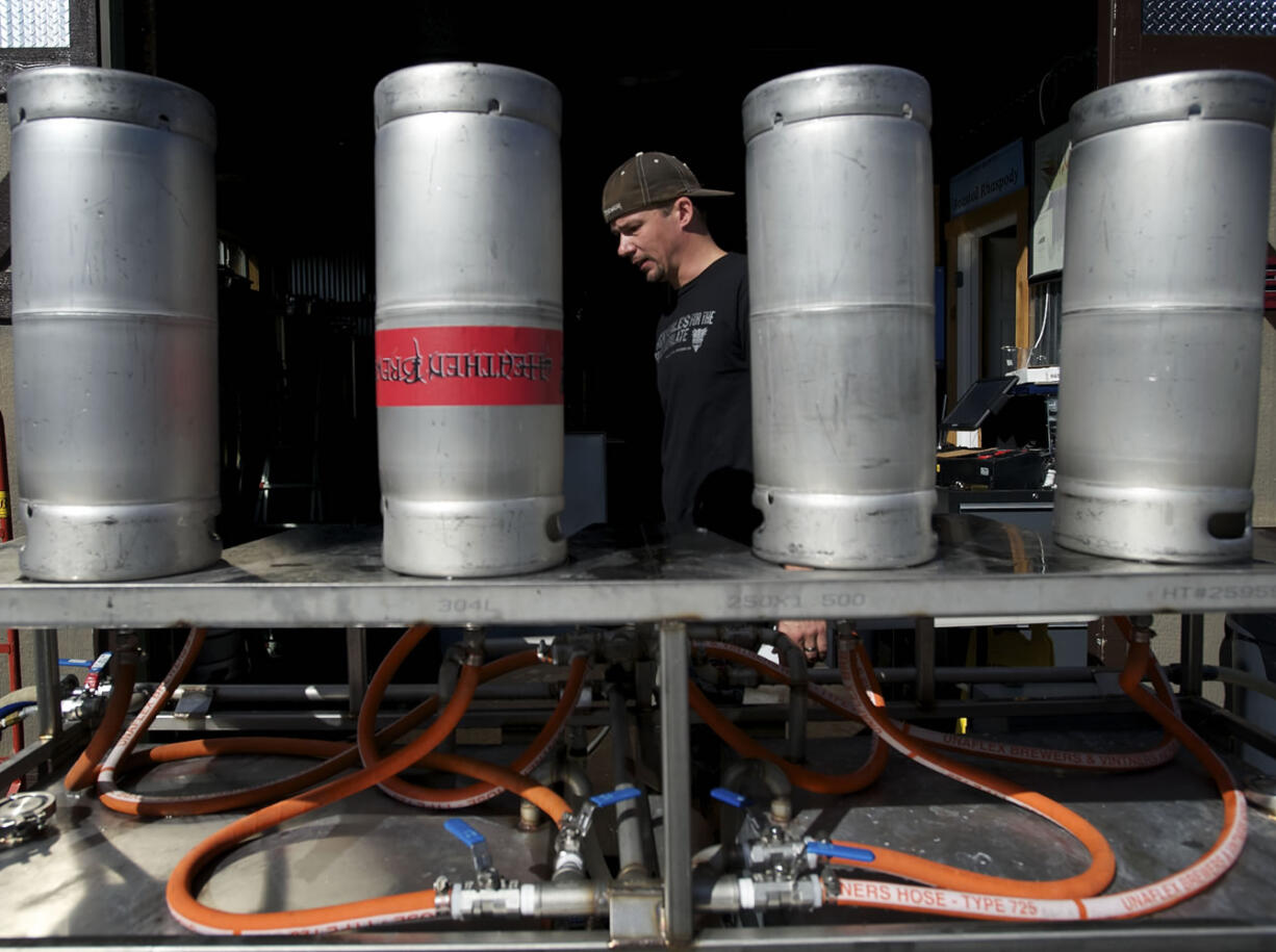 Heathen co-owner and brewer Sunny Parsons washes kegs on a Saturday afternoon.