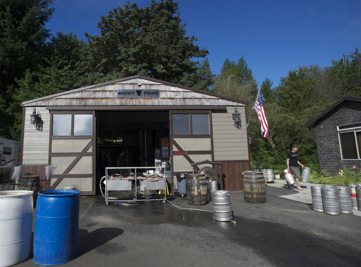 Heathen co-owner and brewer Sunny Parsons prepares to wash kegs.