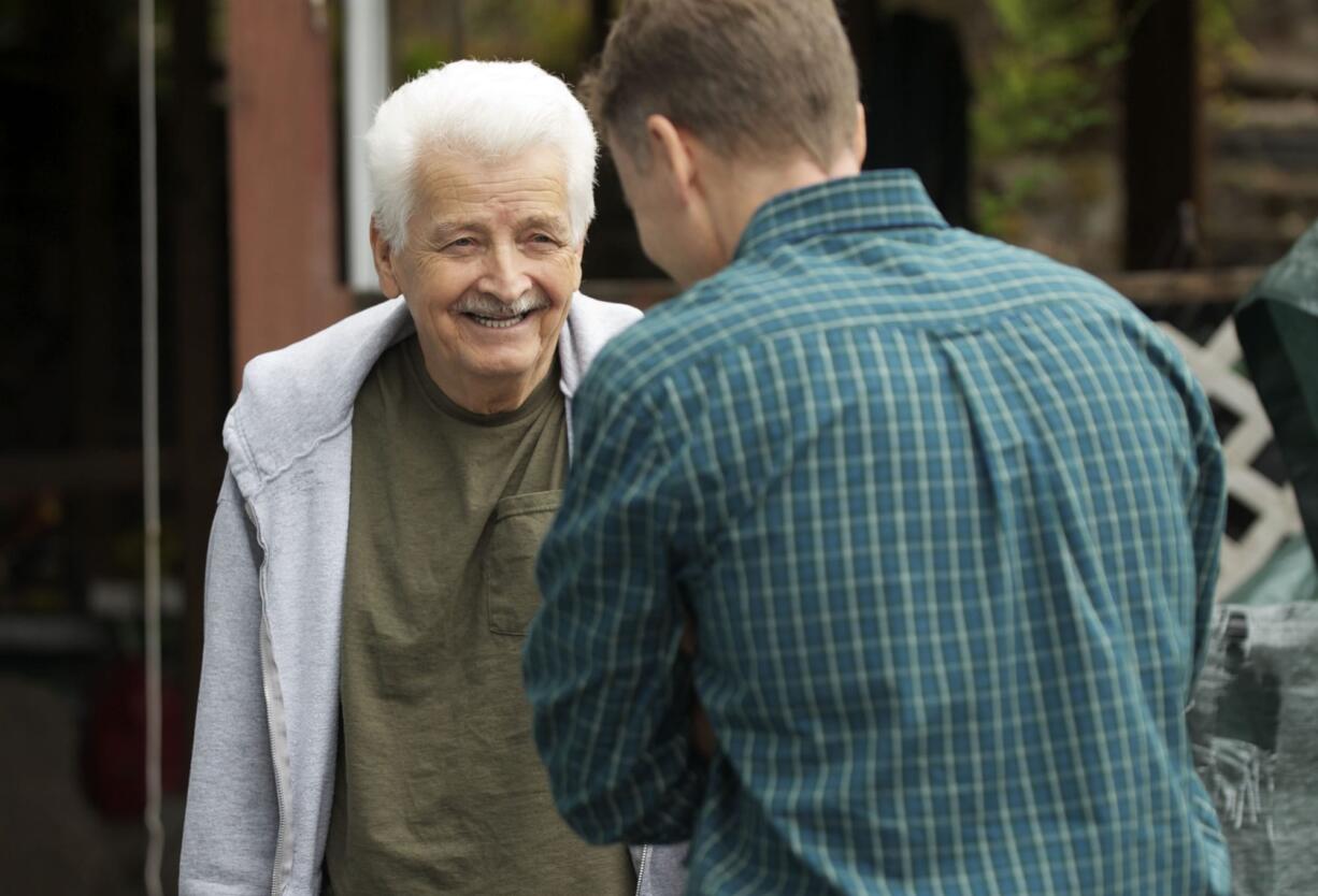 Clyde Kment, left, talks Tuesday with John Ross, manager of the Home Depot store in Tigard, Ore.