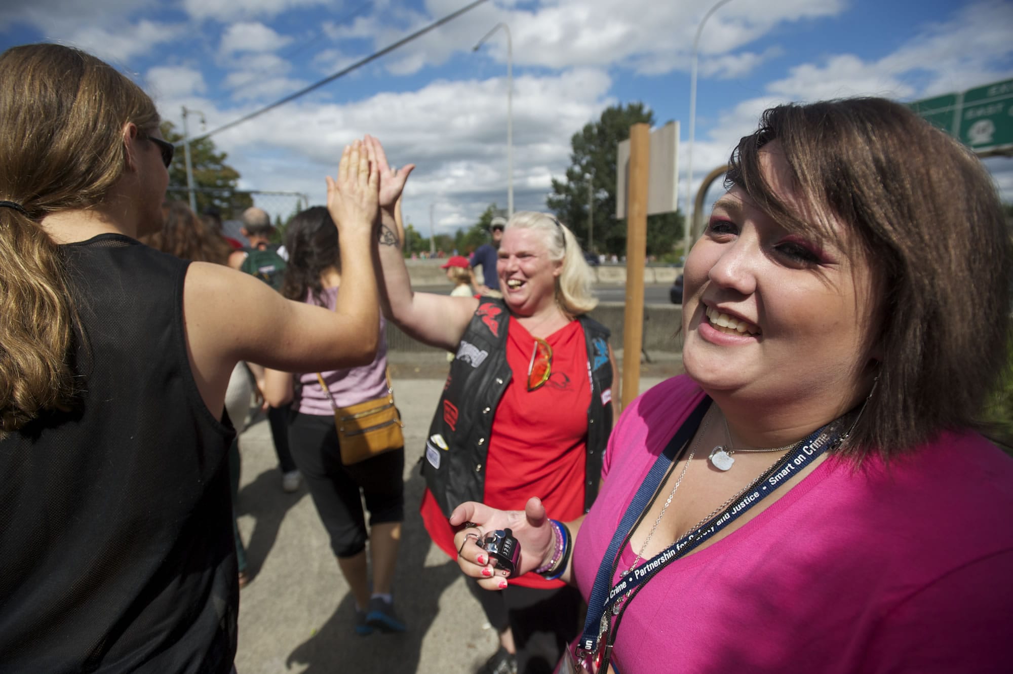 Recovering addict Torrie Licht, 19, of Vancouver uses a counter to track the number of people filing onto the I-5 Bridge during Hands Across the Bridge on Monday.