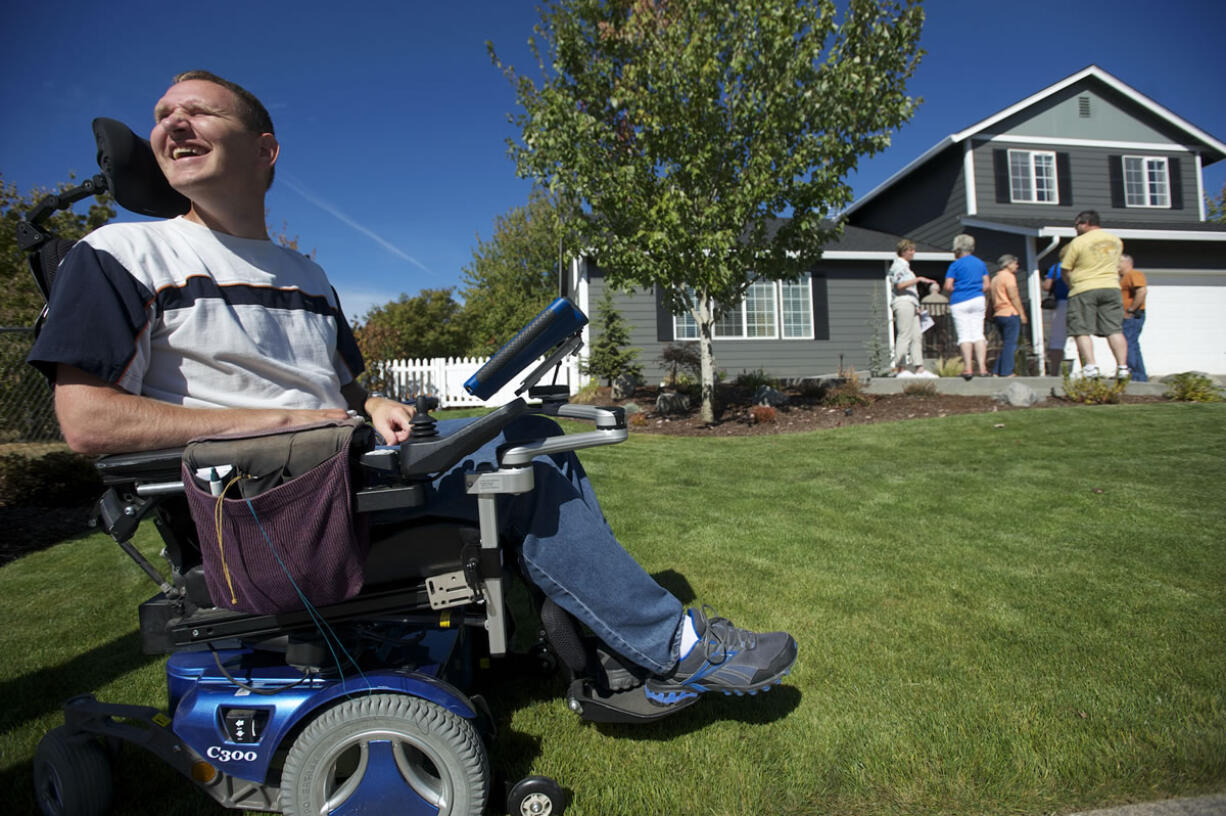 Brian Epp, 42, relishes the sight of his newly renovated home at an open house he and his wife, Jennie, held Saturday to show of the fruit of volunteer hours and donated money for a home makeover to make the family's home wheelchair-accessible.