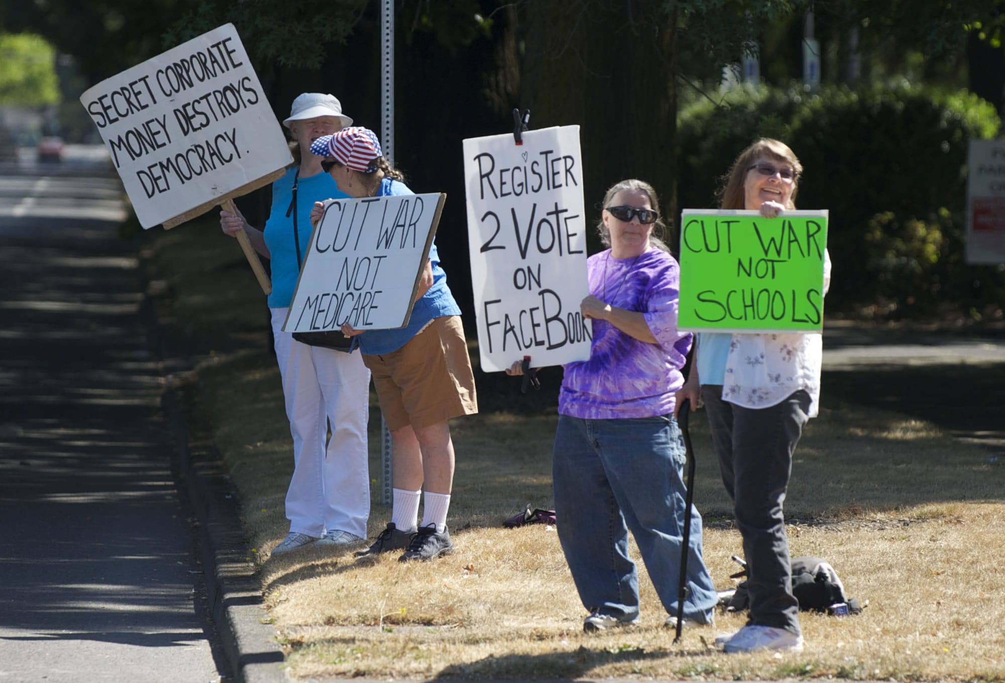 Steven Lane/The Columbian
Occupy Vancouver supporters wave signs Thursday, as they do most weeks, at Mill Plain Boulevard and Fort Vancouver Way.