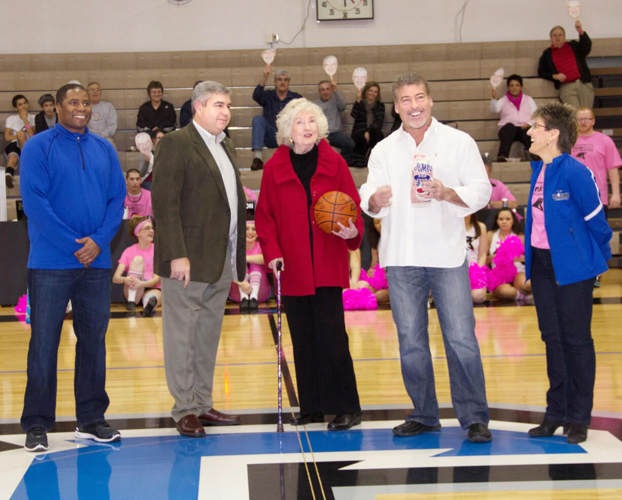 Central Park: During Bob Moser Night at a Clark College men's basketball game Feb. 16, his widow, Mary Lou, center, was surprised when the crowd held up masks of the former college spokesman. The masks were distributed to the audience by the Clark College Foundation.