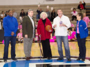 Central Park: During Bob Moser Night at a Clark College men's basketball game Feb. 16, his widow, Mary Lou, center, was surprised when the crowd held up masks of the former college spokesman. The masks were distributed to the audience by the Clark College Foundation.